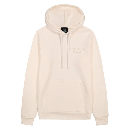 A unisex cream hooded sweatshirt adorned with the D'naja logo. The sweatshirt features a stylish and versatile design, perfect for both men and women. The cream color adds a sleek and modern touch to the garment. The prominent D'naja logo is displayed on the front, showcasing the brand's identity with its distinctive typography. The hood provides added comfort and warmth, making this sweatshirt a fashionable and practical choice for any casual occasion or chilly weather